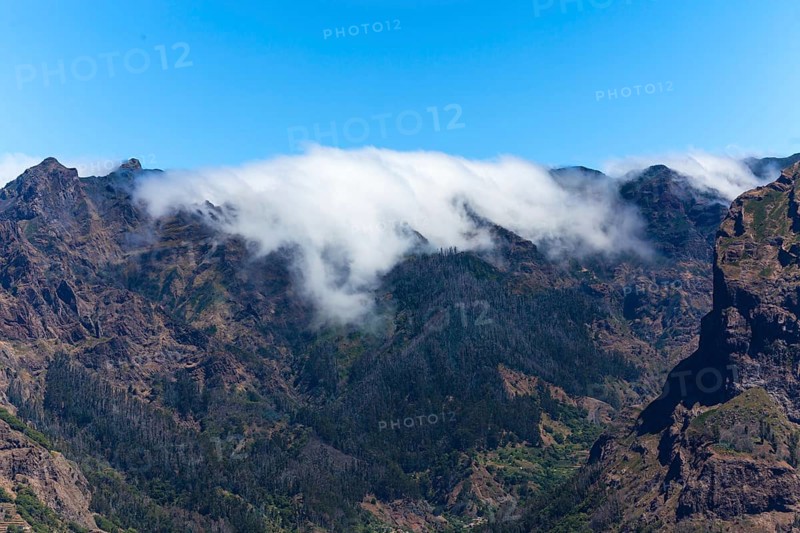 View of the mountains and deep gorges seen from Pico dos Barcelos mountain