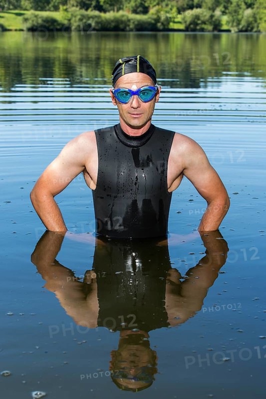 Triathlete standing in Aichstruter Reservoir