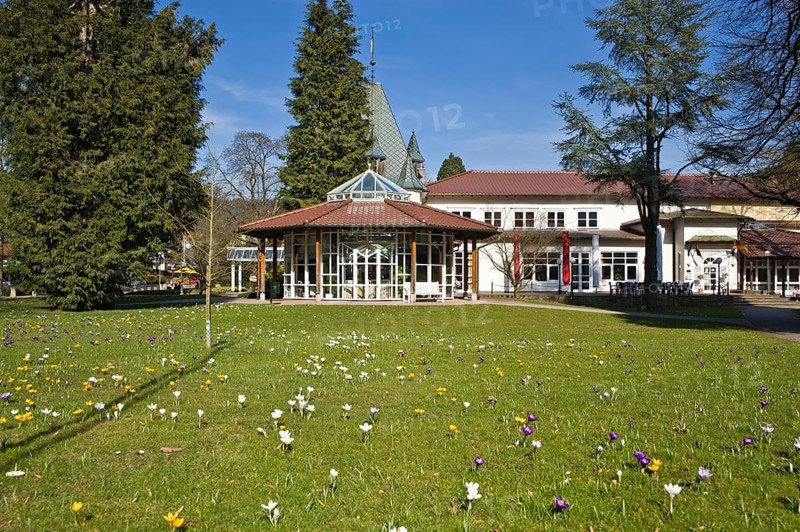 Historic Kurhaus with a pavilion and crocuses in the lawn