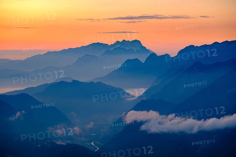 Blue mountain silhouettes at sunrise