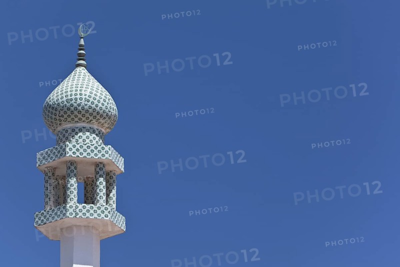 Crescent moon and a star at the top of a minaret