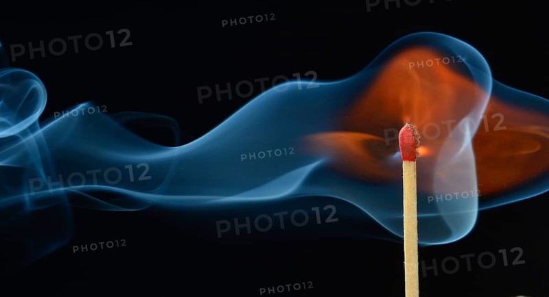 Lit matchstick with a flame and smoke