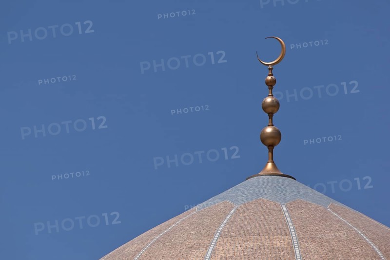 Golden crescent moon on top of a mosque