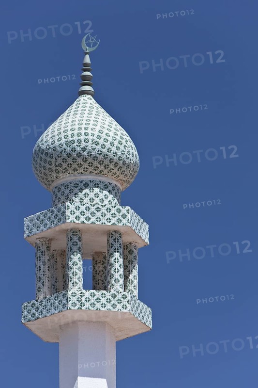 Crescent moon and a star at the top of a minaret