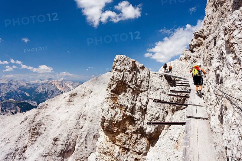Climber climbing along the Via Ferrata Ivano Dibona climbing route on Monte Cristallo to the summit of Cristallino