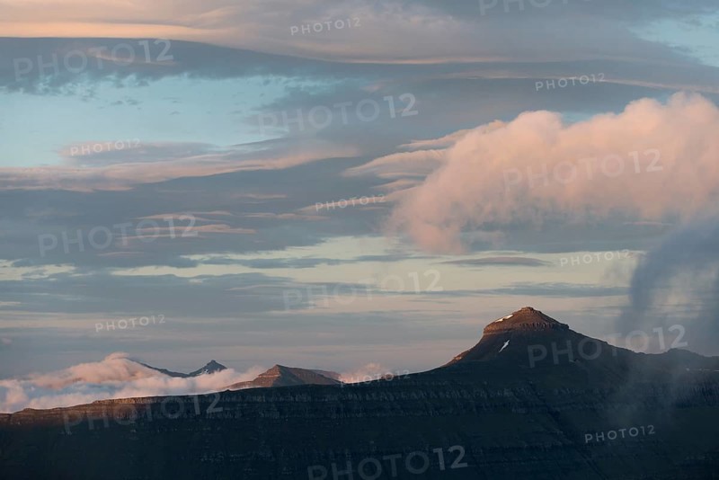 Mountain landscape in the evening light with a cloudy sky