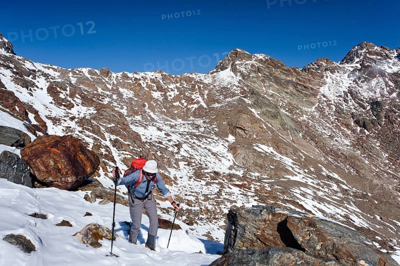 Hiker during the ascent of Hintere Eggenspitze Mountain in the Ulten Valley