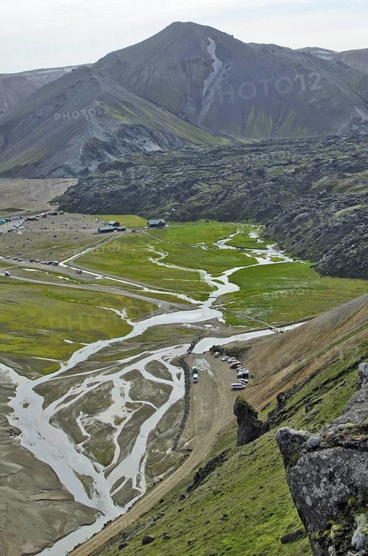 View over the Laugahraun lava field with cabins and a camping site