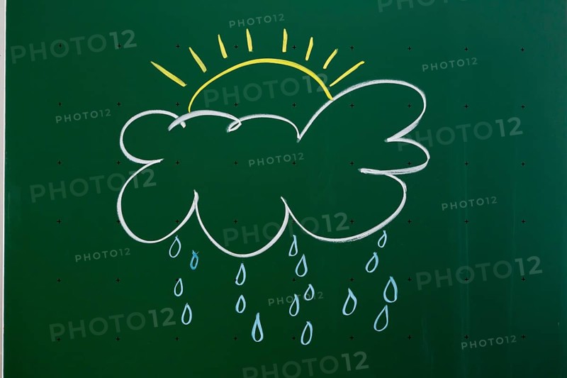 Cloud with a sun and rain drawn with chalk on a blackboard