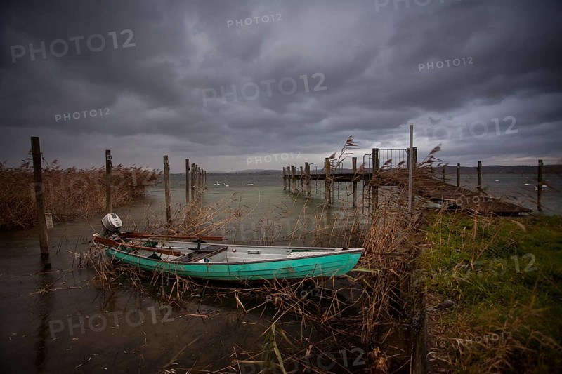 Wooden boat beside a jetty on Lake Constance