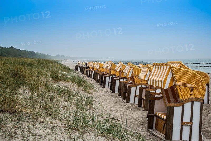 Roofed wicker beach chairs on the beach