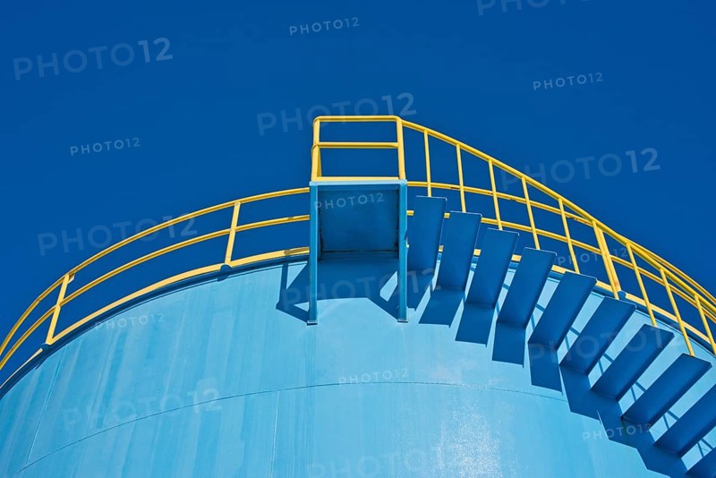 Yellow railings of a blue silo