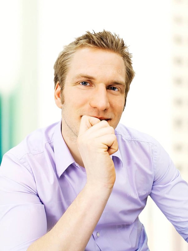 Businessman holding his hand on his chin