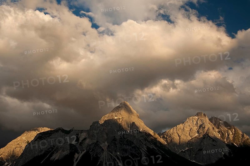 Last sunlight shining on the peaks of the Mieming Range with the mountains Ehrwalder Sonnenspitze and Gruenstein