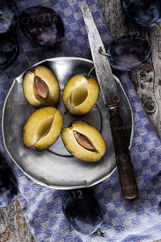 Fresh plums (Prunus domestica) on a tin plate