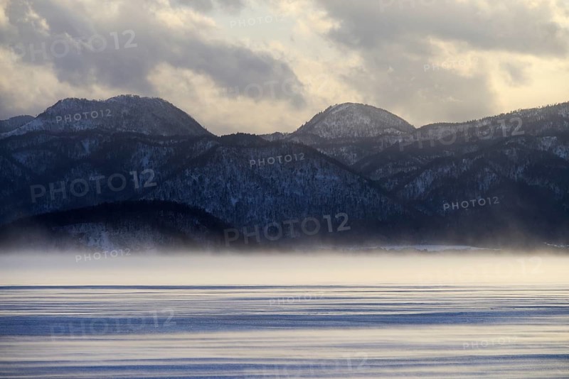 Fog over the frozen Lake Kussharo