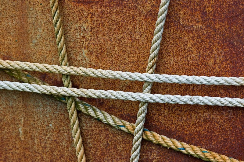 Taut ropes on a rusty surface