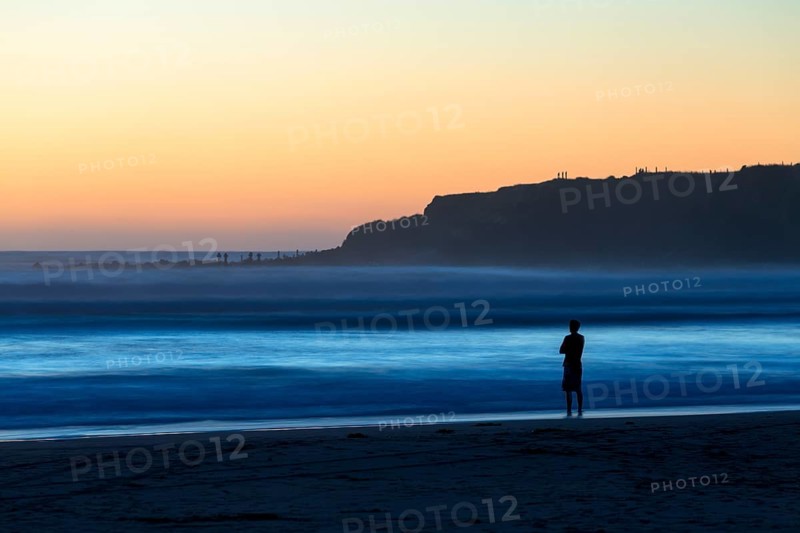 Man on the beach with surf
