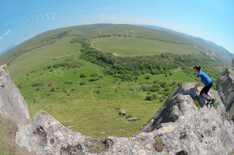 Woman looking down a cliff