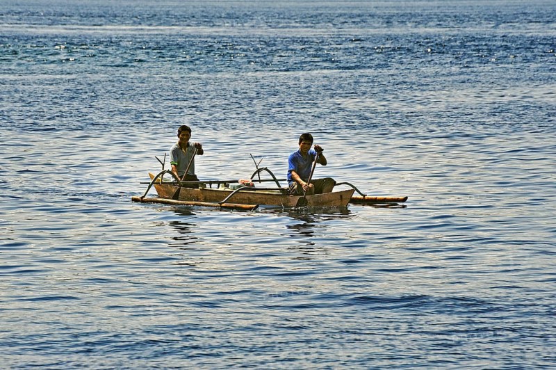 Two men in an outrigger boat