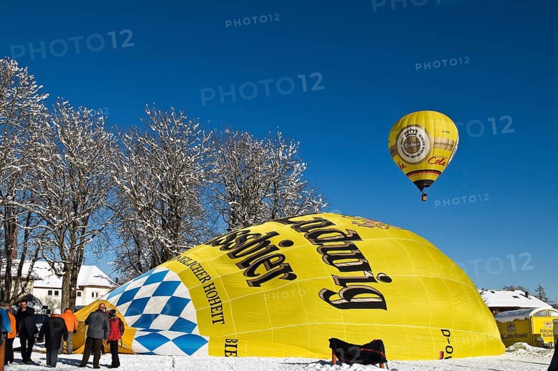 Balloons in the air or balloon envelope being inflated on the ground
