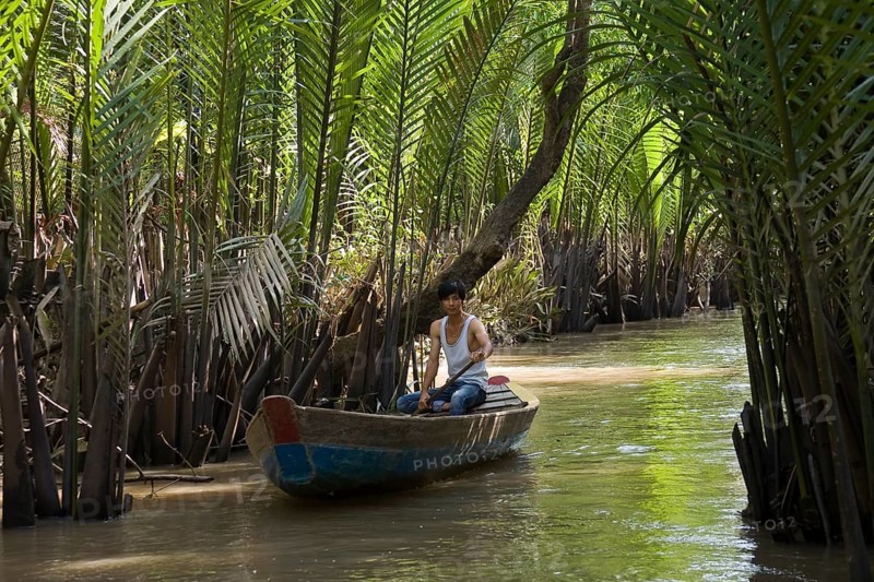 Boatman on a tributary of the Mekong Delta