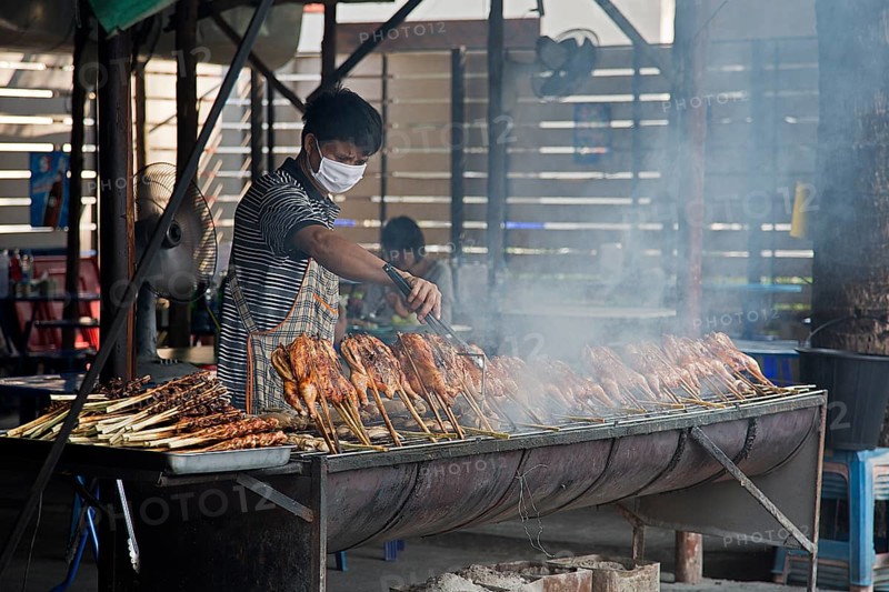 Vendor grilling chicken