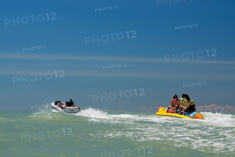 Tourists being pulled on a banana boat ride