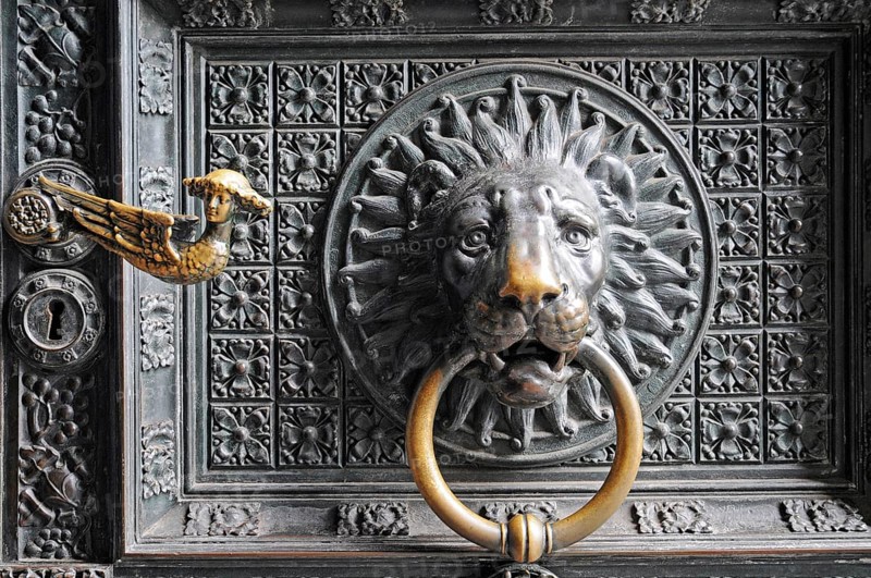 Lion head door knocker on the entrance portal
