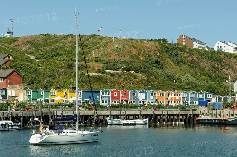 Sailing ship in the harbour of Heligoland or Helgoland in front of Hummerbuden or lobster shacks