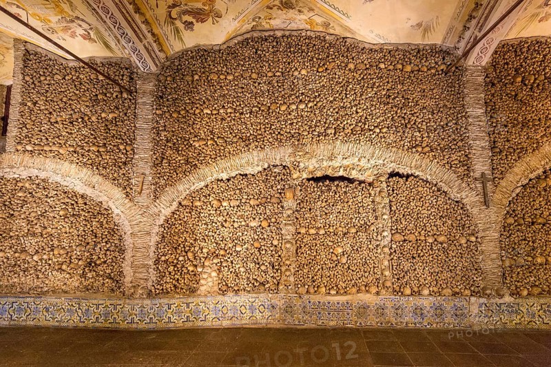 Stacked bones and skulls in the ossuary