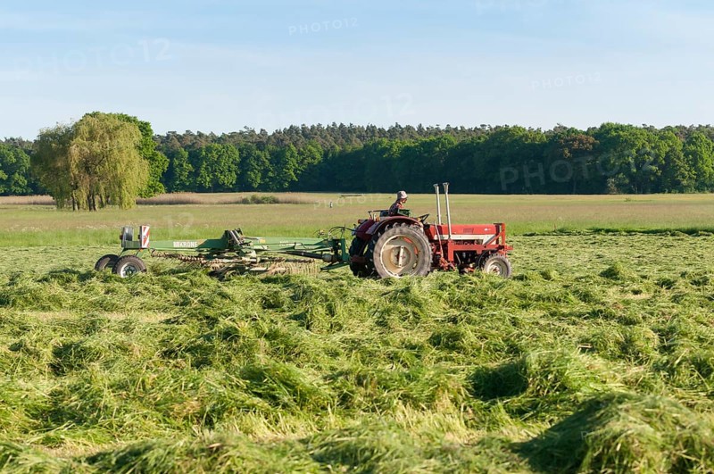 Tractor with hay turning machine
