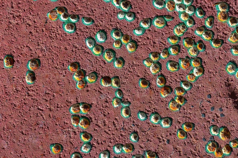 Painted surface with small coloured dents