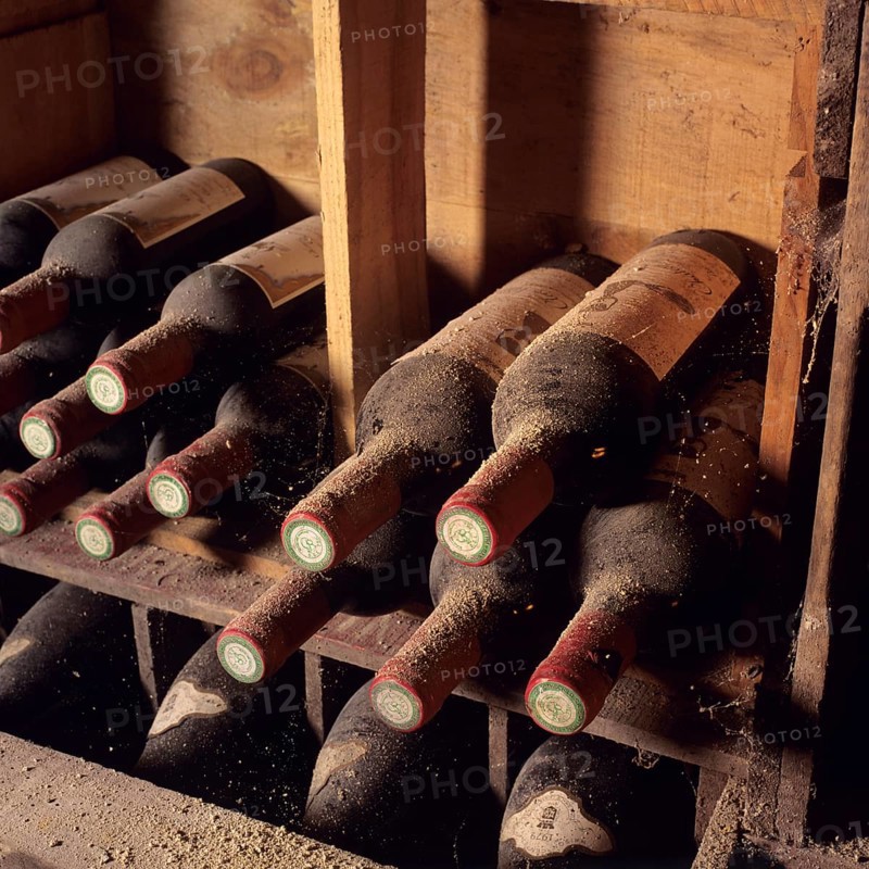 Dusty bottles of Bordeaux wine in a cellar
