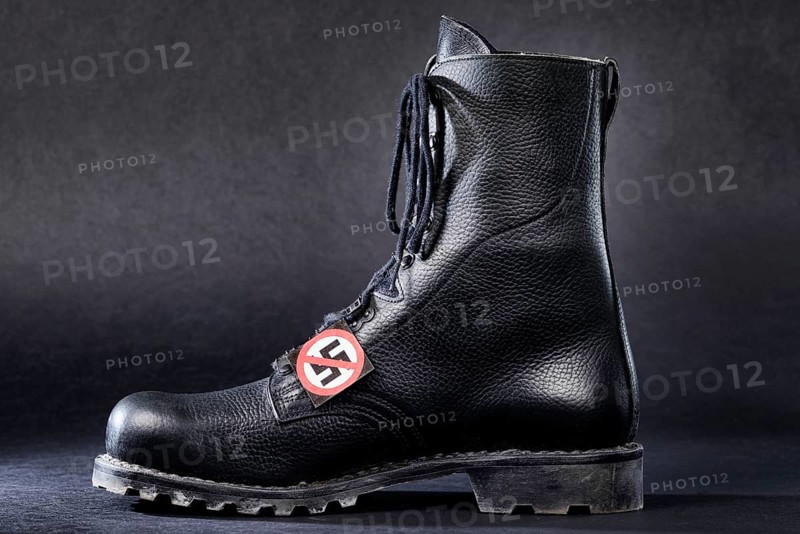 Combat boot with a badge with a crossed-out swastika