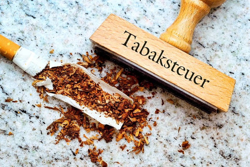 Cigarette and a stamp labelled 'Tabaksteuer'