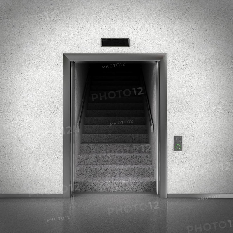 Open elevator doors revealing stairs behind them