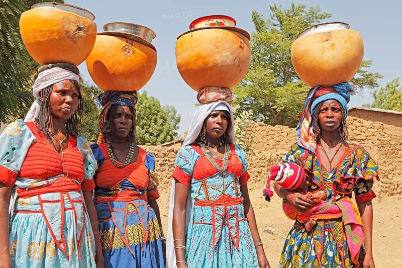 Fulani women carrying milk calabashes on their heads