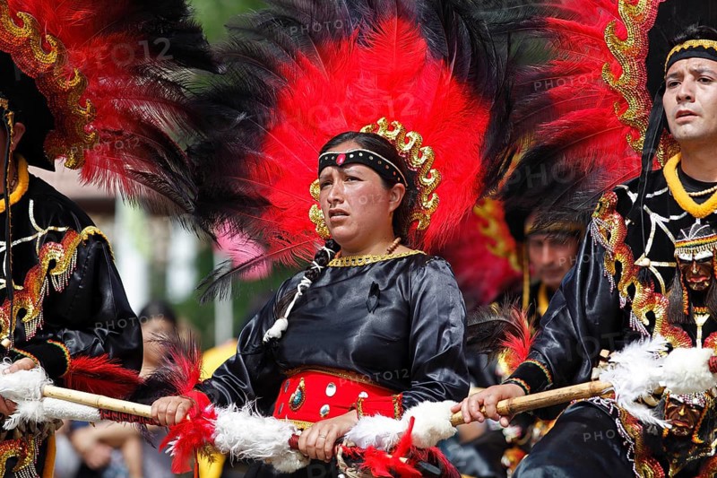 Woman and man wearing festive traditional Indio costumes
