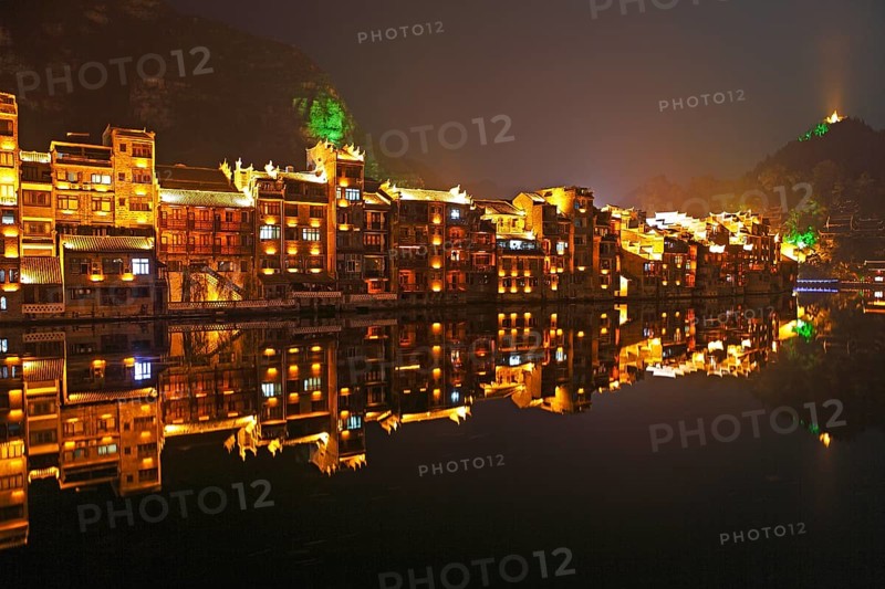 Illuminated houses on the Wuyang River at night