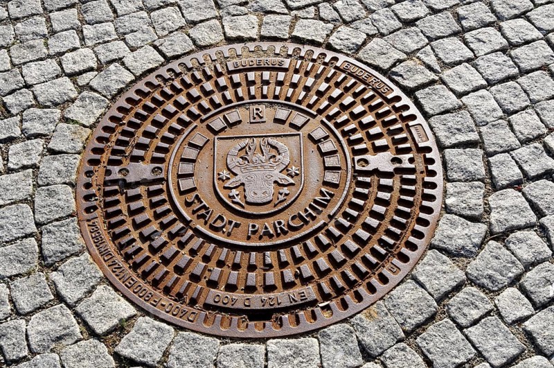 Man-hole cover with inscription