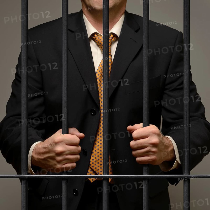 Jailed business man behind prison bars
