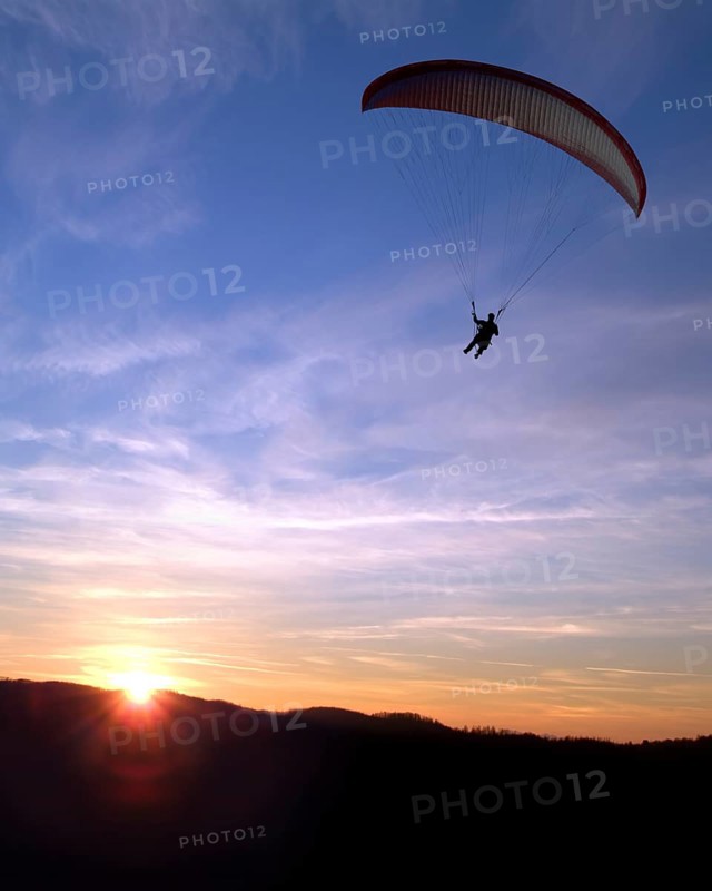 Paraglider at sunset