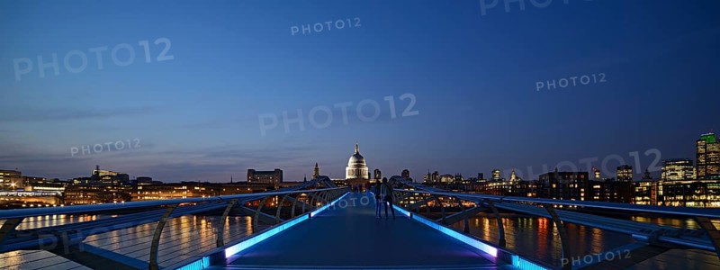 Millennium Bridge and London skyline at dusk