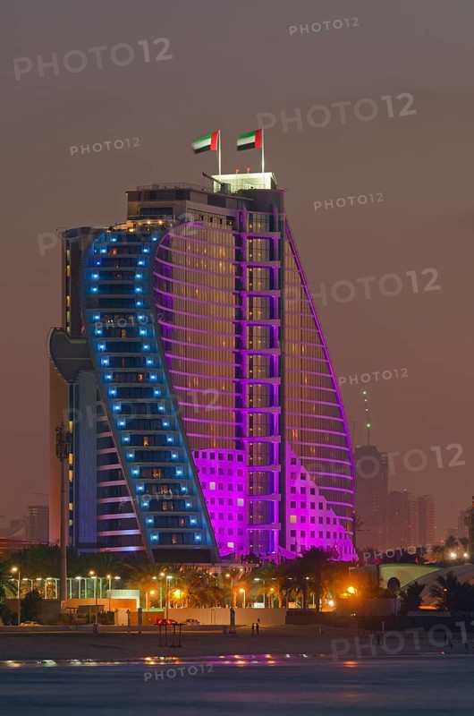 The illuminated Jumeirah Beach Hotel on Jumeirah beach at dusk