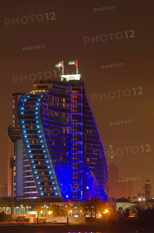The illuminated Jumeirah Beach Hotel on Jumeirah beach at dusk