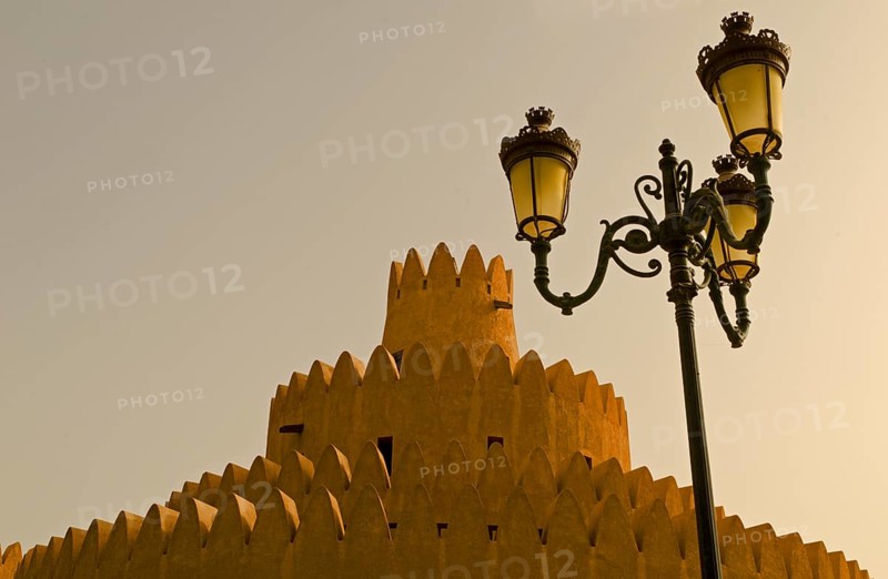 A tower of the Al Ain Palace Museum or Sheikh Zayed Palace Museum and a street lamp
