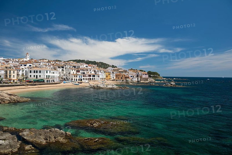 Village with white houses by the sea