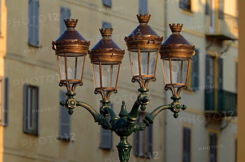 A glorious street lamp in Ajaccio and the facade of a house in the background illuminated by warm morning light. Ajaccio is the capital of the mediterranean island of Corsica