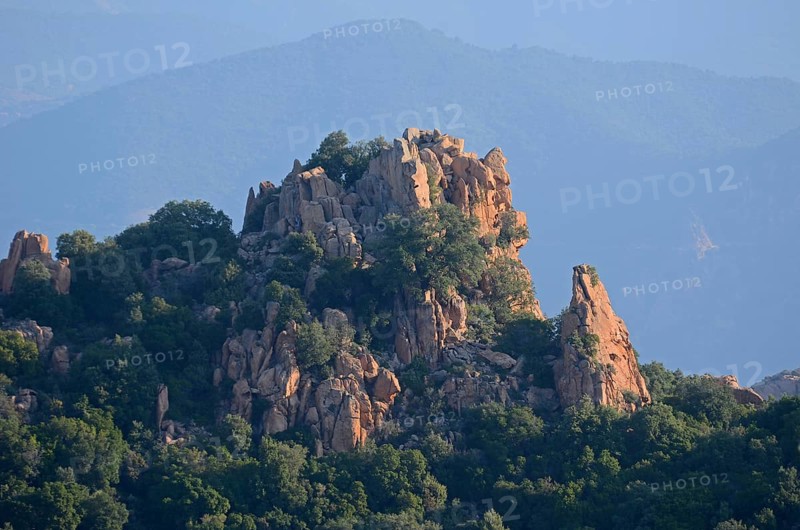 The typical bizarre red rocks of the Calanche of Piana below a blue sky. The Calanche of Piana is in the western part of the island Corsica